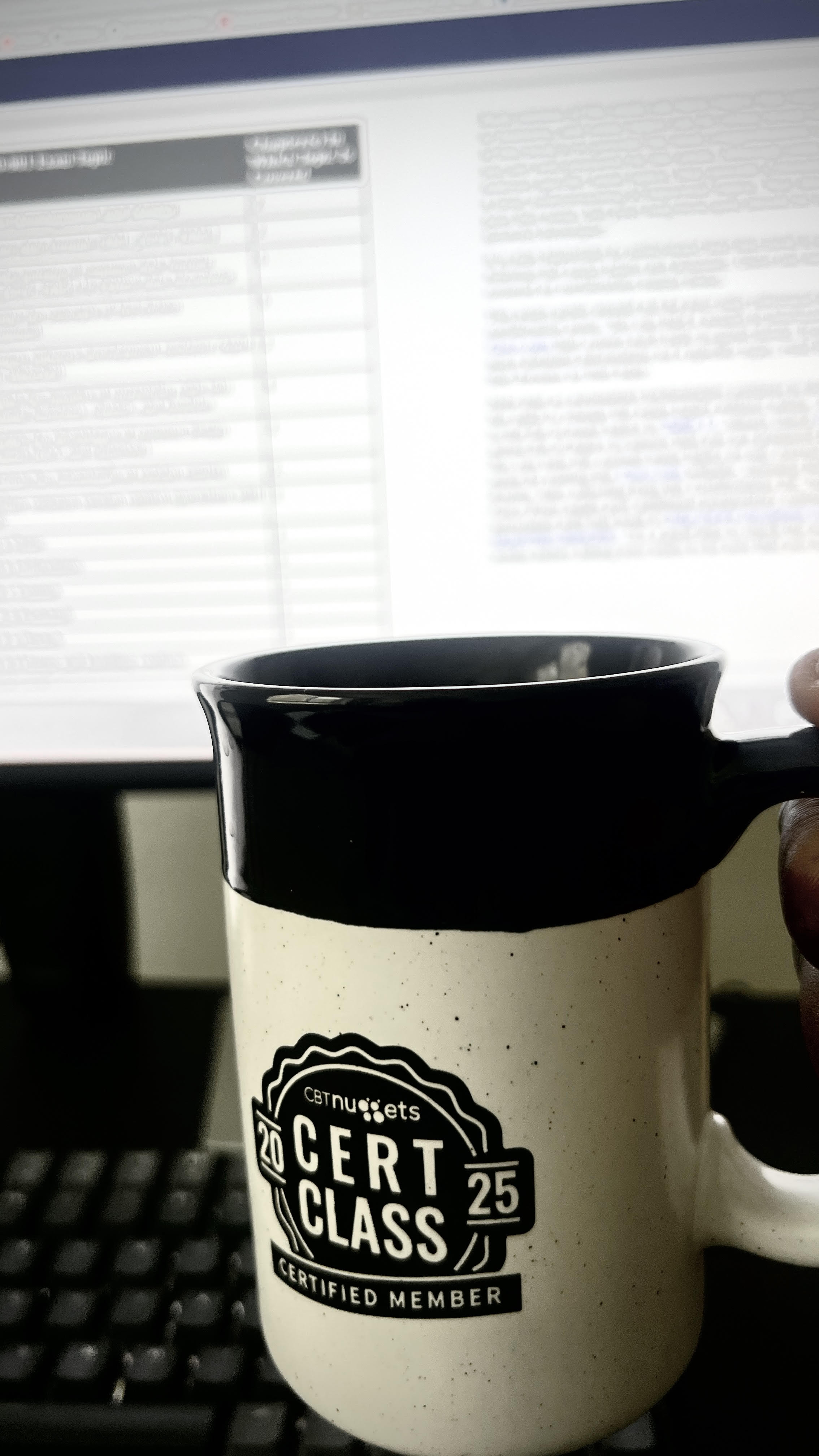 holding a cbtnuggets 2025 cert class mug